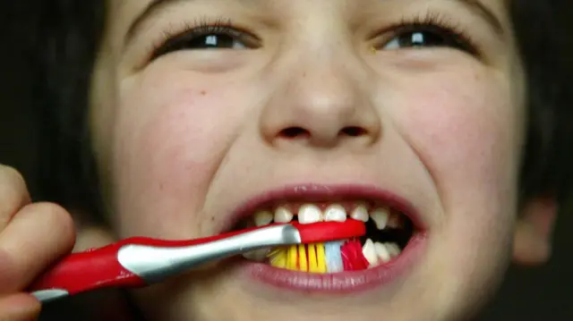 A child brushing their teeth