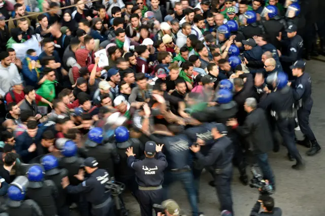 Protesters ram into a police line.