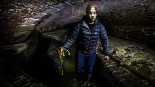 A man explores the city storm drain