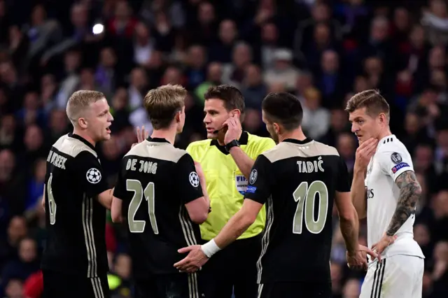 Referee with Real Madrid and Ajax players