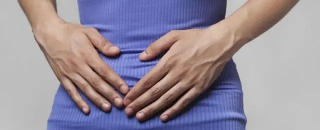 Woman hold stomach/lower abdomen