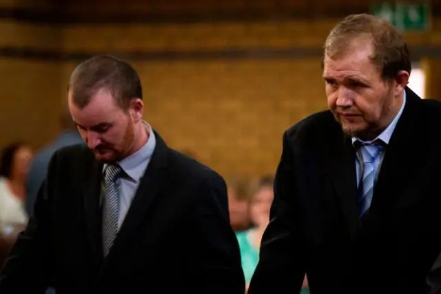 Pieter Doorewaard (L) and Phillip Schutte (R) attend their sentencing hearing in the North West High Court in Mahikeng