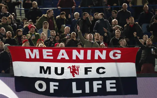 Manchester United fans with 'Meaning of Life' banner