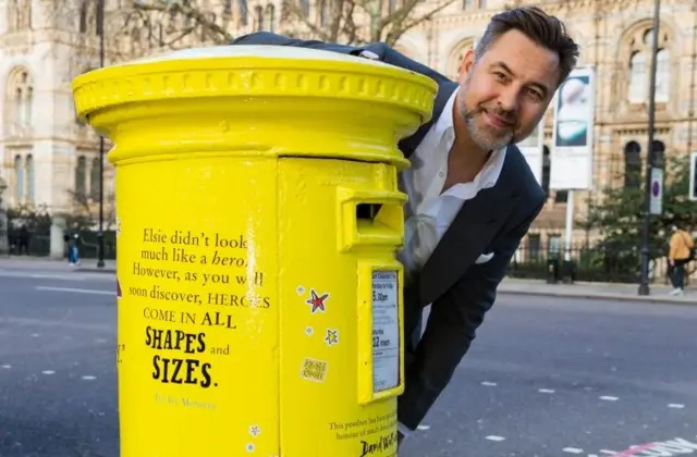 David Walliams with yellow postbox