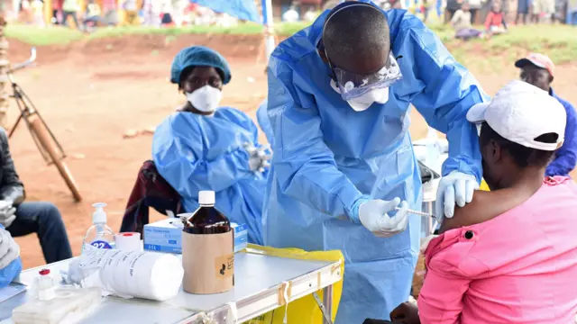 A Congolese health worker administers Ebola vaccine to a woman who had contact with an Ebola sufferer in the village of Mangina in North Kivu province of the Democratic Republic of Congo, 18 August 2018