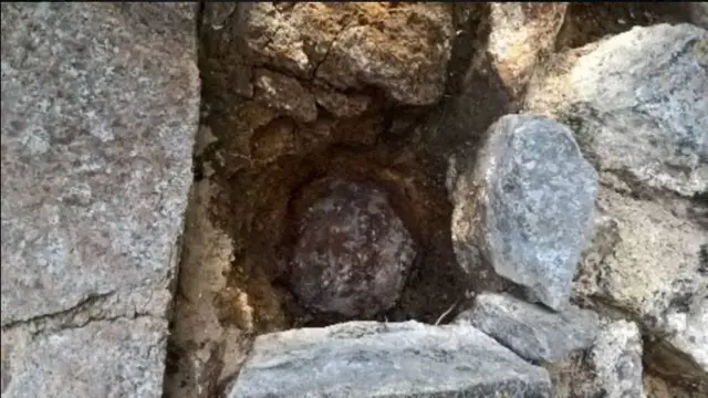 A cannonball lodged in a wall