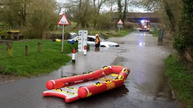 Car in flooded ford