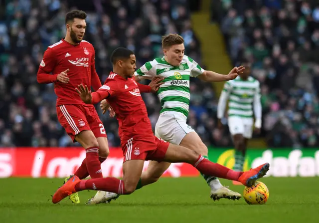 Max Lowe challenges Celtic's James Forrest for the ball