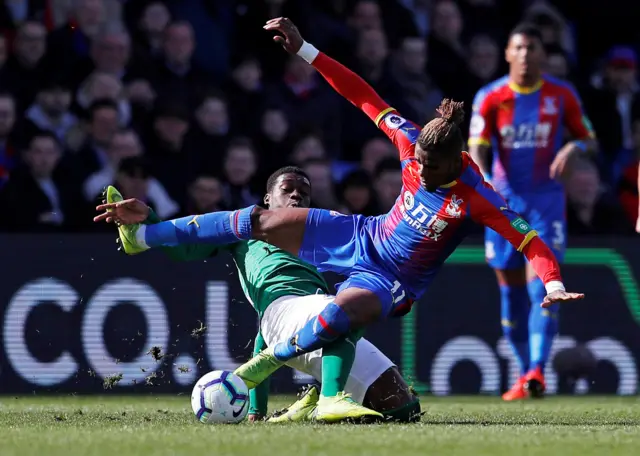 Yves Bissouma tackles Wilfried Zaha