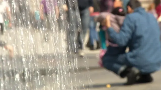 Man and girl by a waterfall blurred