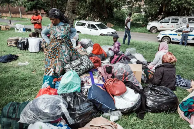 Some people among hundreds of foreign nationals take refuge at a park near the Sydenham Police Station soon after foreign nationals were displaced during xenophobic attacks in Durban on March 27, 2019 following violence against immigrants and other foreigners