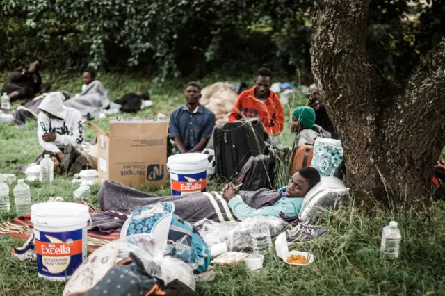 Hundreds of foreign nationals take refuge at a park near the Sydenham Police Station soon after foreign nationals were displaced during xenophobic attacks in Durban on March 27, 2019 following violence against immigrants and other foreigners