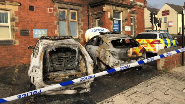 Police cars burnt