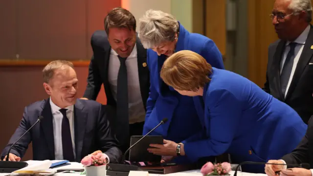 Leaders laughing at an iPad