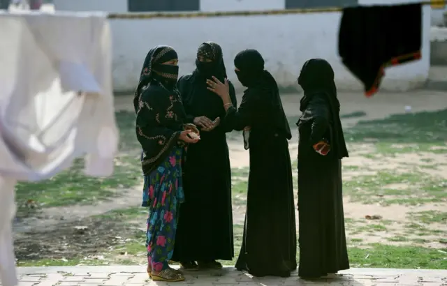 Indian women chat near a polling station in Muzaffarnagar in Uttar Pradesh state.