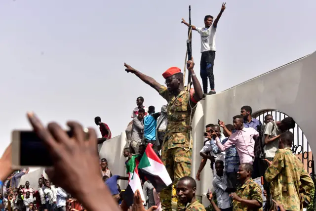 Members of the Sudanese military gather in a street in central Khartoum on April 11, 2019, after one of Africa"s longest-serving presidents was toppled by the army