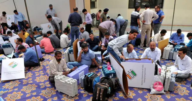 Election officials seen checking Electronic Voting Machine (EVM), Voter Verifiable Paper Audit Trail (VVPAT) and other election-related material after collecting them from a distribution centre, on April 10, 2019 in Jammu, India