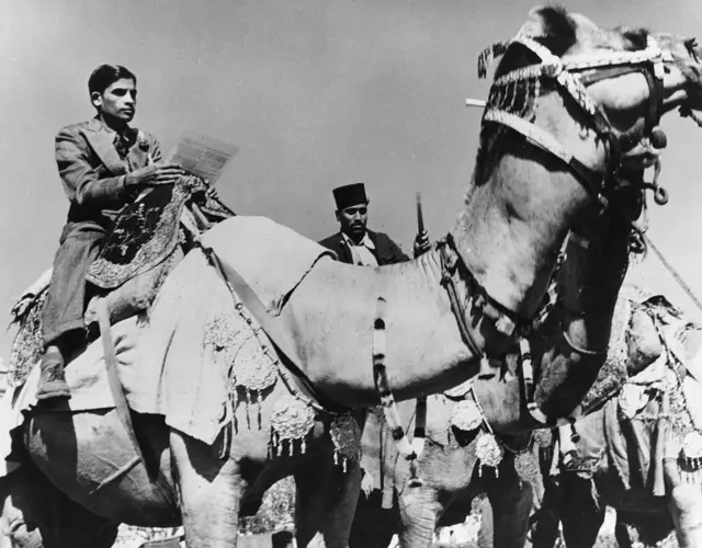 A candidate on a camel is seen campaigning ahead of an election in the 1950s