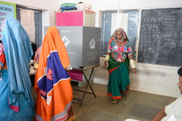 An Indian lambadi tribeswoman leaves a booth after voting at a polling station during India's general election at Pedda Shapur village on the outskirts of Hyderabad on April 11, 2019