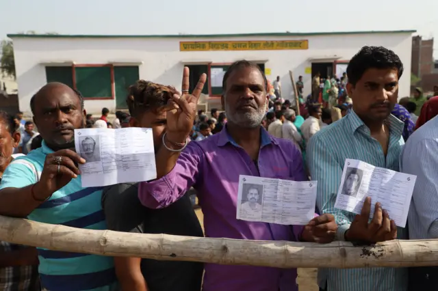 People wait in queue to cast their votes in the first phase of general elections in the northern state of Uttar Pradesh.