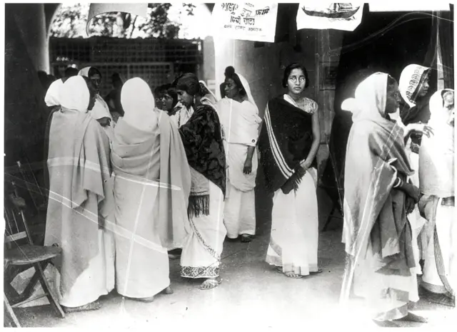 Women outside a polling both in the 1950s.