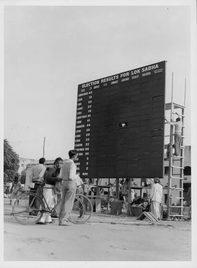 An election news board, Parliament Street, Connaught Place, New Delhi, India, 1962.