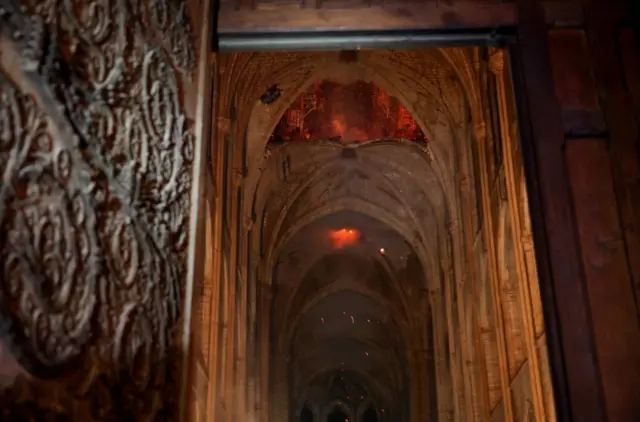 Flames can be seen from the interior of Notre-Dame cathedral in Paris