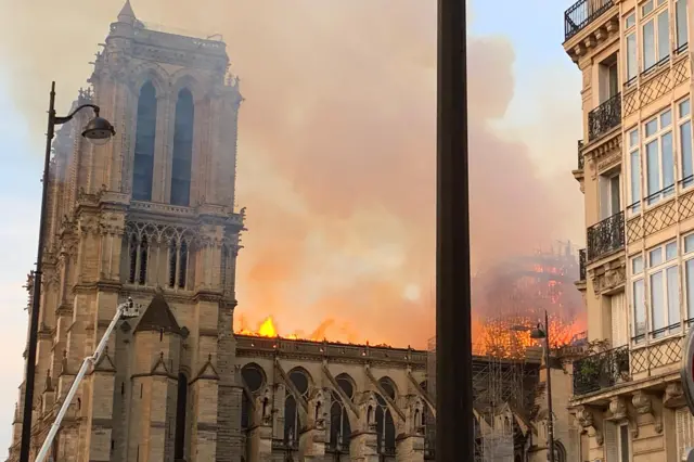 Flames and smoke are seen billowing from the roof of Notre-Dame cathedral in Paris