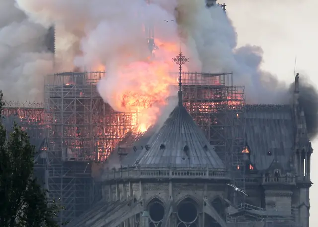 Smoke billows as flames destroy the roof of the landmark Notre-Dame Cathedral in central Paris