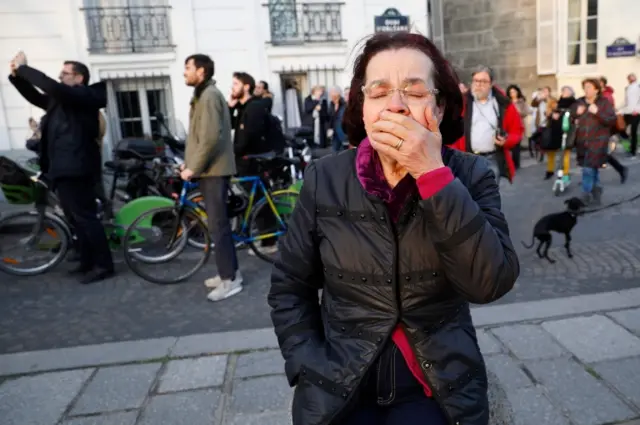 A woman cries as the church burns