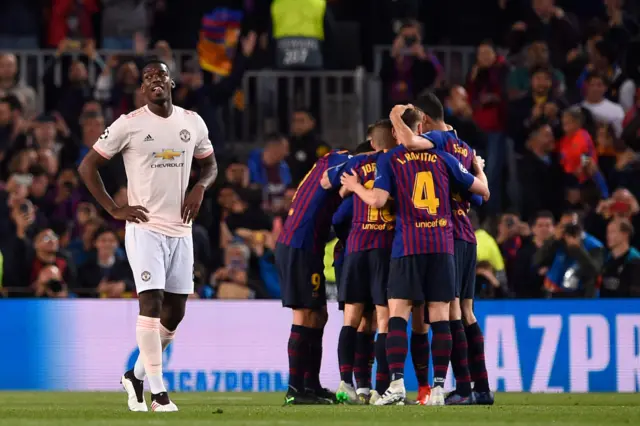 Paul Pogba looks away as Barcelona celebrate