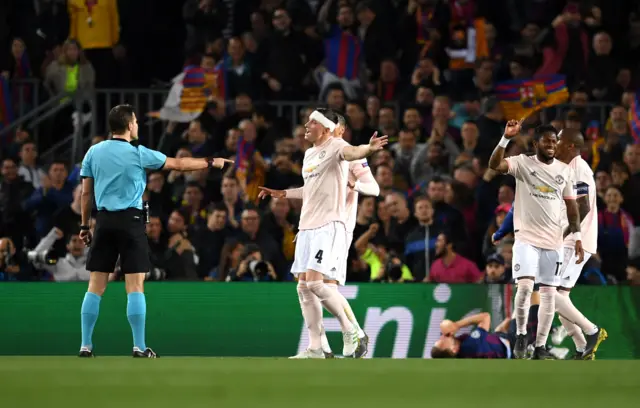 Referee Felix Brych points to the spot