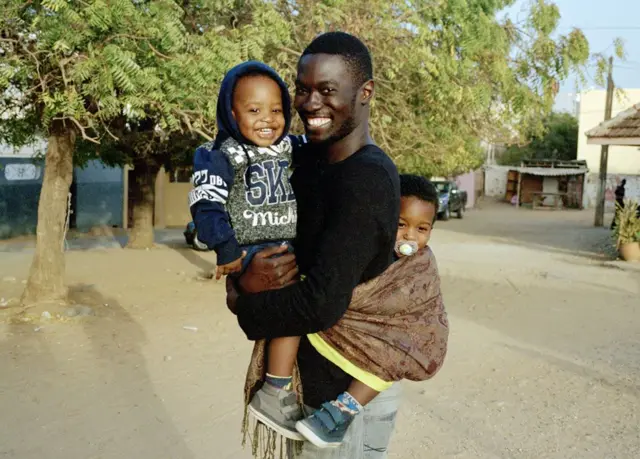 Dad carrying children