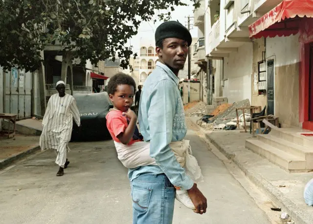 Dad carrying children