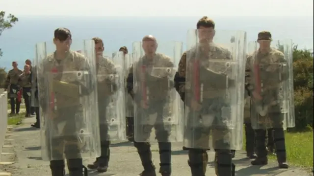 Soldiers with riot shields