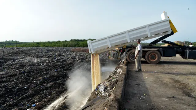 Rice being poured into a landfill