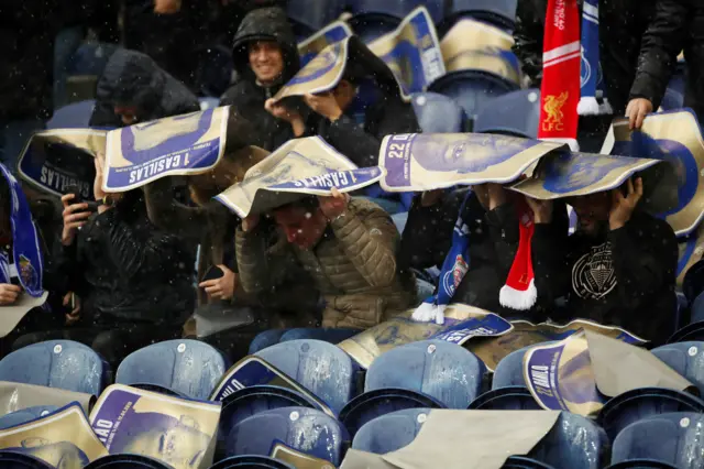 Fans shelter from the rain inside Porto's Estadio do Dragao