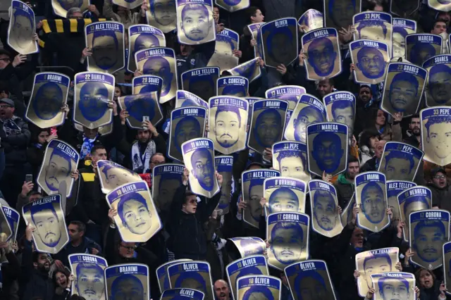 Porto fans hold up cards of their famous players