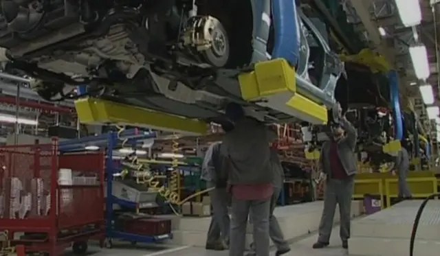 workers under a car