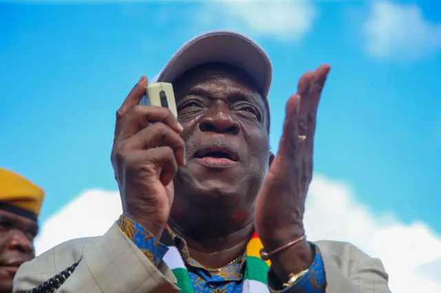 Zimbabwean President Emmerson Mnangagwa addresses a crowd in an area hit days earlier by Cyclone Idai, on March 20, 2019 in Chipinge, Zimbabwe.