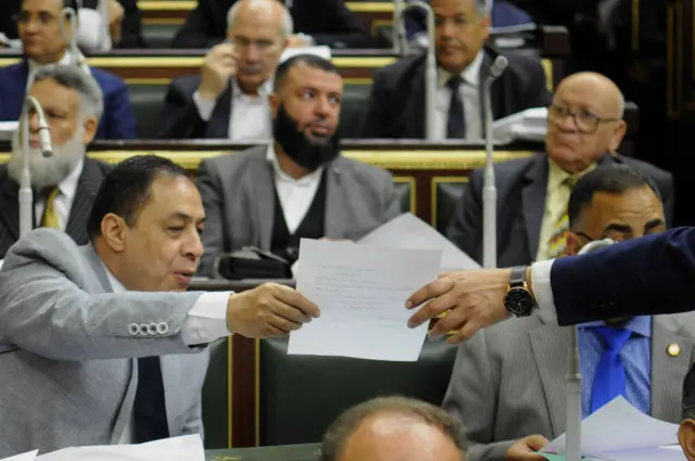 Egyptian MPs attend a Parliament session to view the report of the parliament's Legislative and Constitutional Affairs Committee regarding the constitutional amendments that would allow President Abdel-Fattah el-Sisi to stay in power beyond 2022, when his current and final term ends.