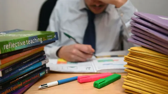 man looking at books