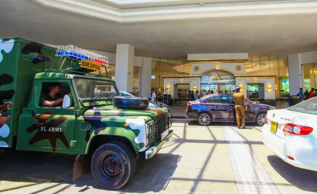 Security forces inspect the scene after a blast targeted the Cinnamon Grand hotel in Sri Lanka