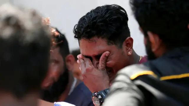 A man mourns outside St Anthony's church