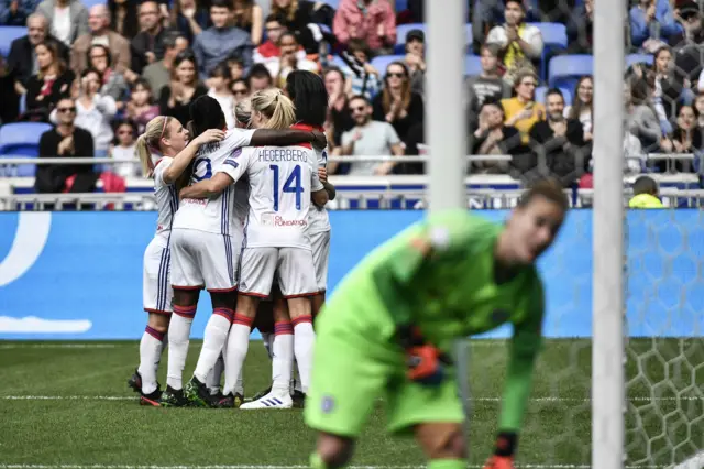 Lyon celebrate a goal against Chelsea