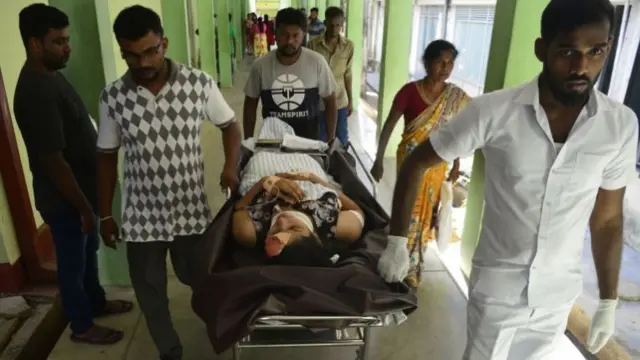 An injured woman is transported on a stretcher in Batticaloa