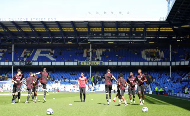 Manchester United players warm up at a sun-drenched Goodison Park