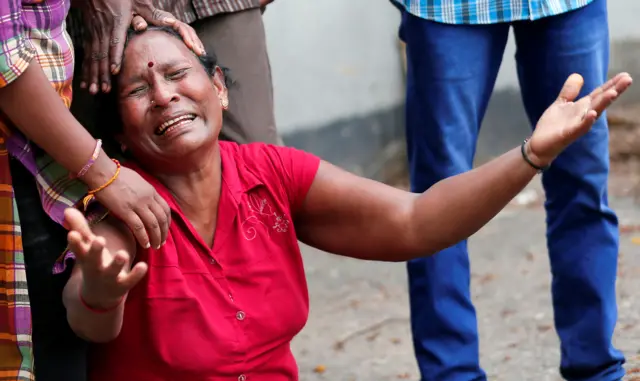 A relative of a victim of the explosion at St. Anthony"s Shrine, Kochchikade church, reacts at the police mortuary