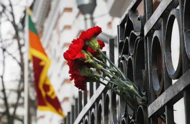 Flower tributes to victims are placed on the wall near the entrance of Sri Lanka embassy in Moscow, Russia, 22 April 2019.