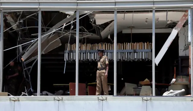 A police officer inspects the explosion area at Shangri-La hotel in Colombo, Sri Lanka April 21, 2019